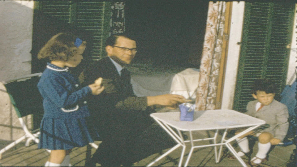 16mm film passing through the wet gate on a modified Bell & Howell scanner — frame-by-frame capture